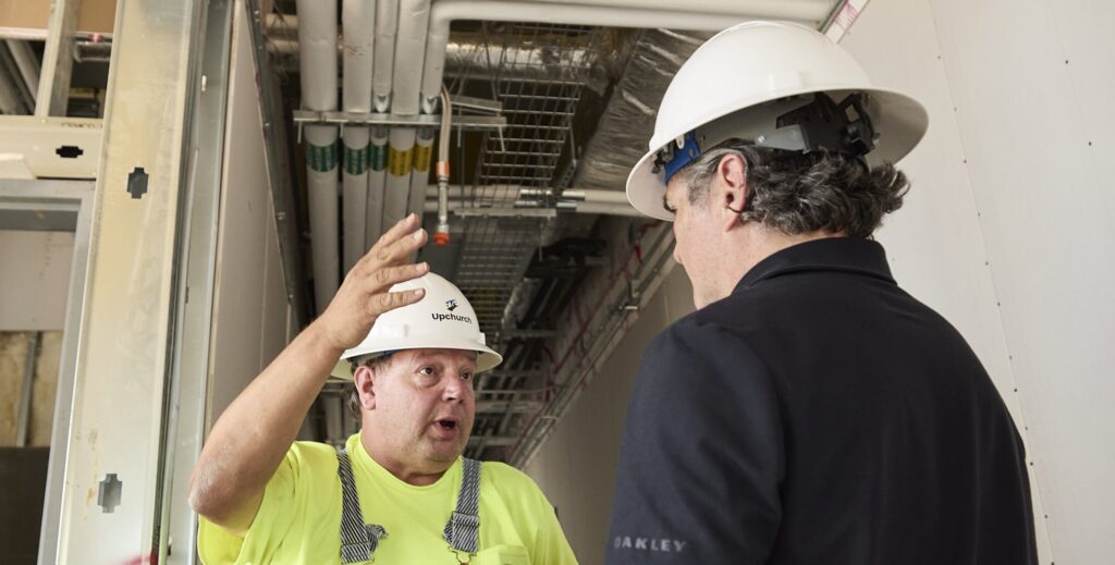 Two Upchurch employees discussing on a project site.