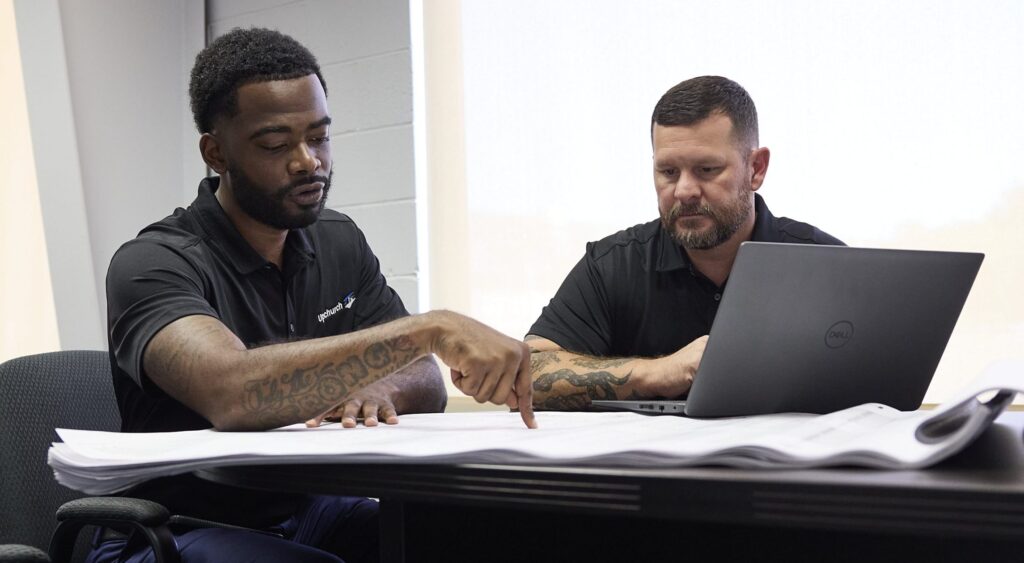 Two Upchurch employees reviewing the plans for a project