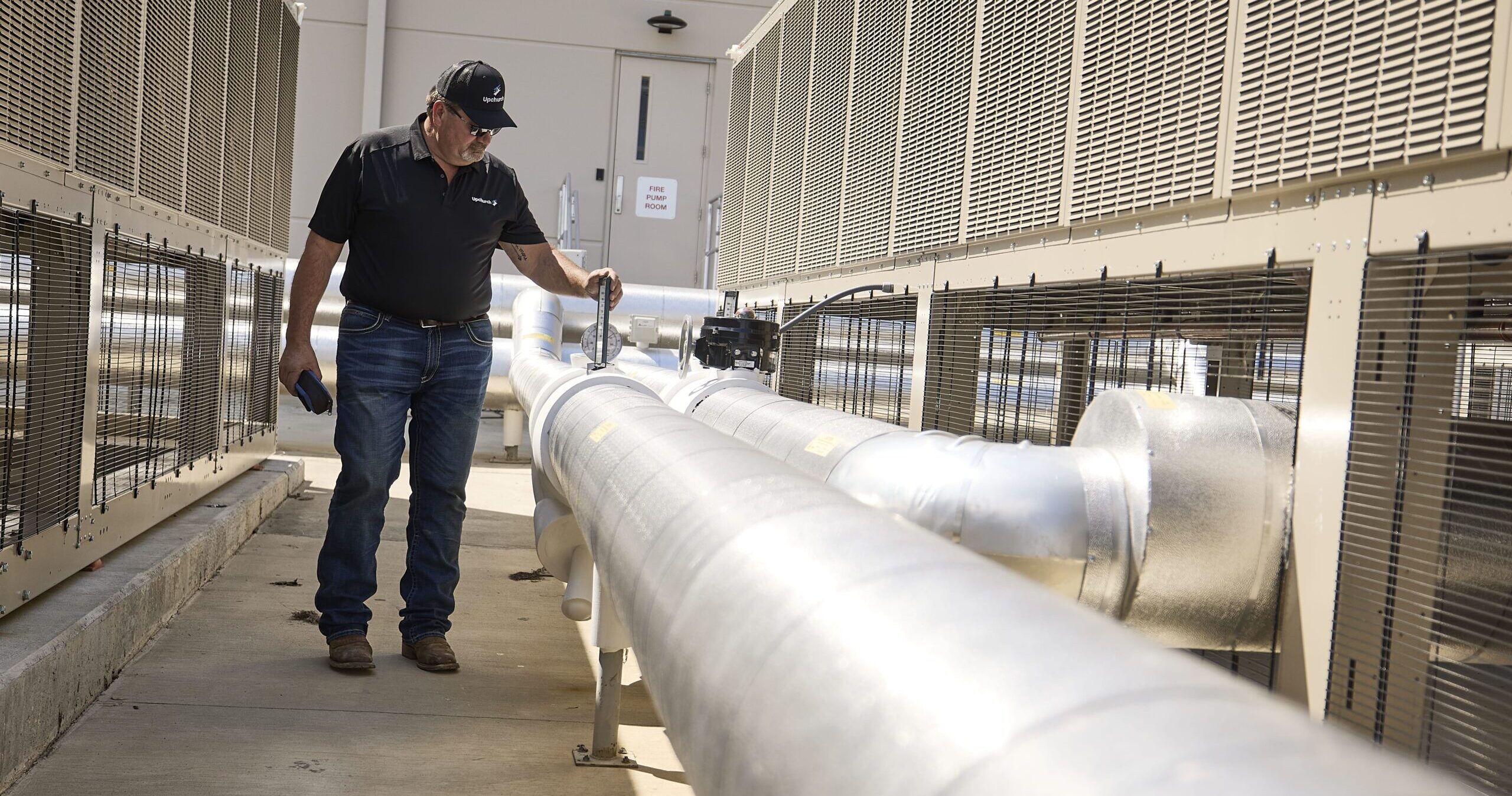 An Upchurch employee analyzing a large pipe