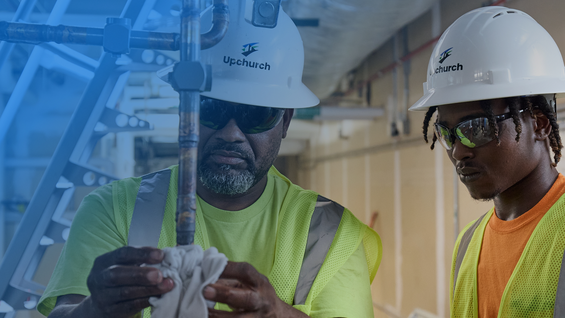 Two Upchurch technicians performing work on a pipe